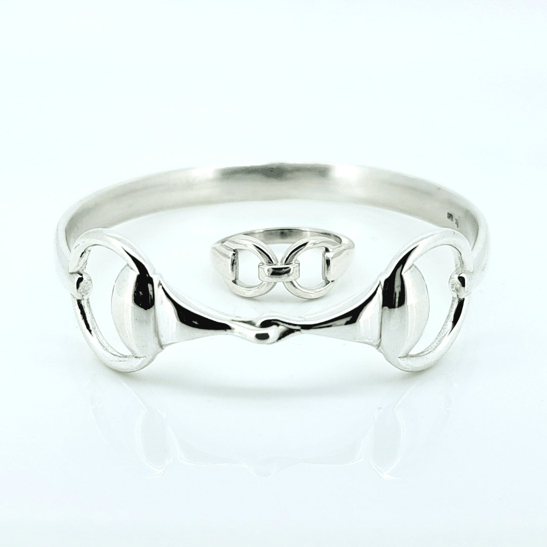Product photo of Crawford Equestrian Jewellery sterling silver Snaffle Bit Ring and Snaffle Bangle laid flat together, showing the matching equestrian jewellery set.
