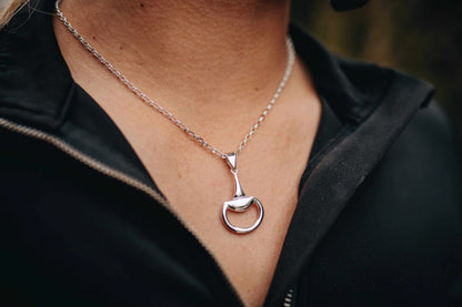 Equestrian Pendant in polished silver, featuring a minimalist half-snaffle design with a rounded D-ring and slender bale