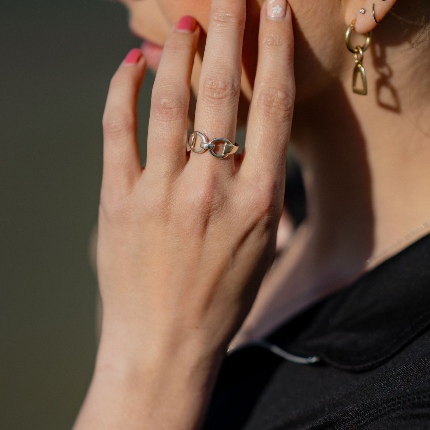 Photo of a horse rider wearing a silver horse bit snaffle ring made by Crawford Hill Equestrian Jewellery.