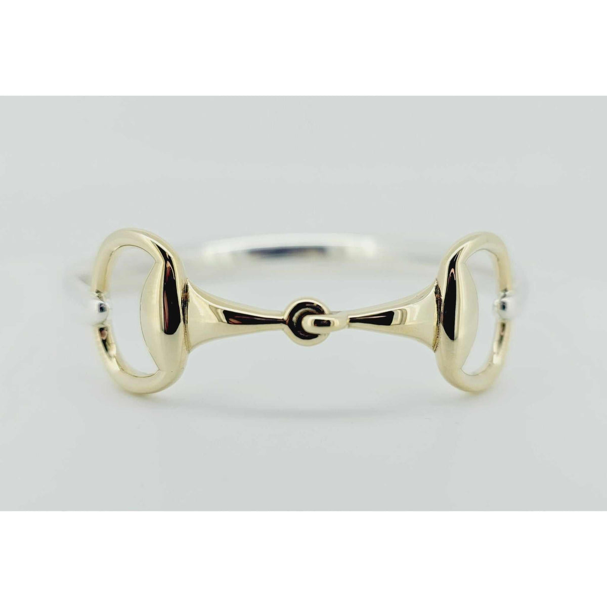 Product photo of horse bit snaffle bangle, horse jewelry in gold and silver. Bangle made by Crawford Hill Equestrian Jewellery. 