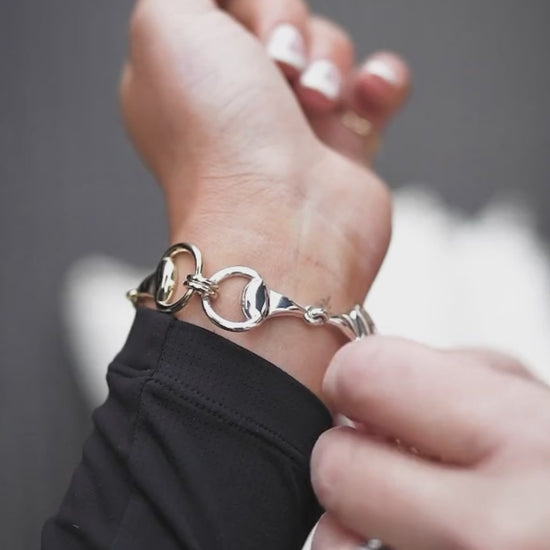 Equestrian horse rider wearing a Three Snaffle Bracelet made by Kelly Crawford. 