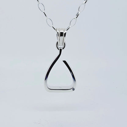 Product shot. Silver jump stirrup necklace. Set with one diamond. Based on the Freejump Stirrup. This is for Horse riders and equestrians. Made by Crawford Hill Equestrian Jewellery.