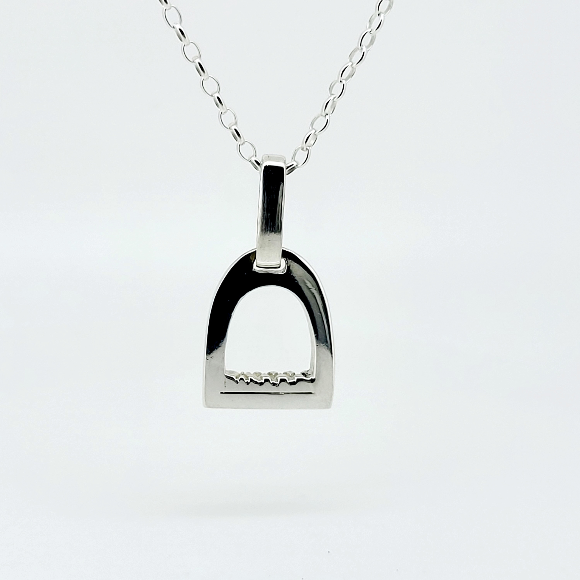 Product photo of small silver stirrup necklace. Made to be worn by horse riders by Crawford Hill Equestrian Jewellery.