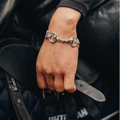 Snaffle Bracelet in polished silver, featuring three sculpted horse-bit links joined in an articulated equestrian design