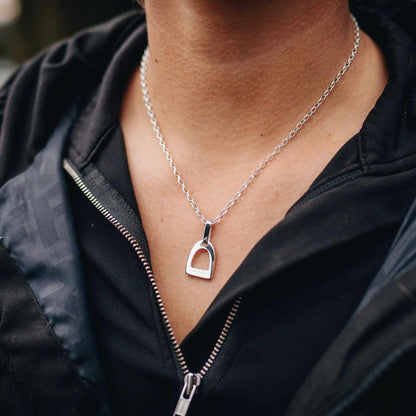 Stirrup Pendant in polished silver, featuring a small classic stirrup-shaped charm on a fine silver chain