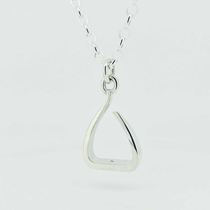 Stirrup Pendant in polished sterling silver, with a sculptural open stirrup shape and matching silver chain